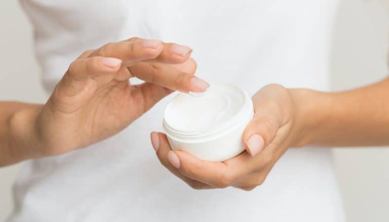 Woman using moisturizing cream for clean and soft skin