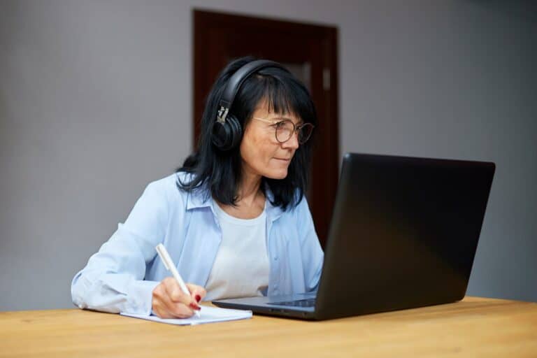 Senior woman student learning language, watching online course