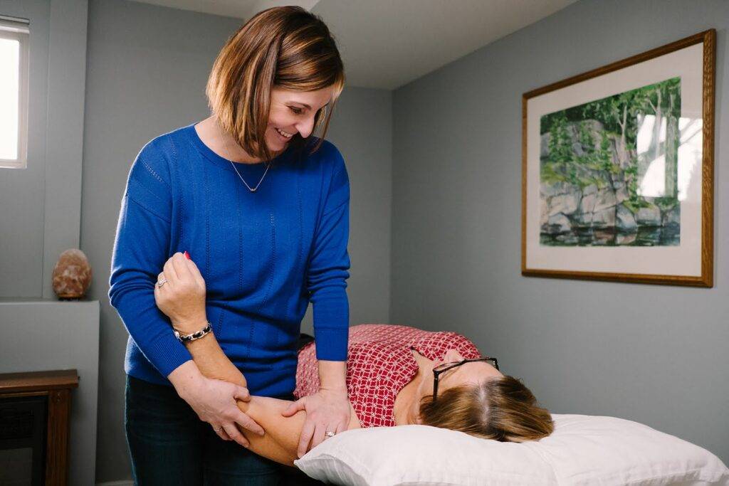 Breast cancer physiotherpist Beth Hoag works with a client in Ottawa doing cancer rehabilitation in a one-on-one in-person session.