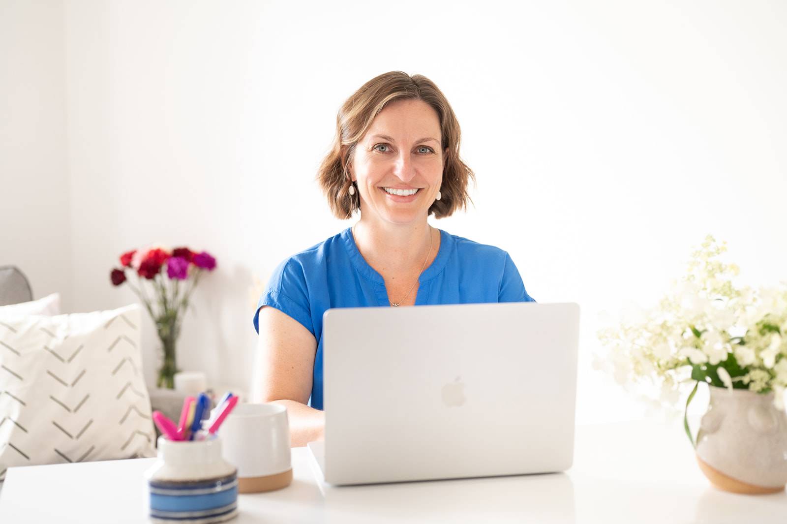 Beth Hoag at her computer creating online cancer rehabilitation programs for individuals facing a cancer diagnosis.